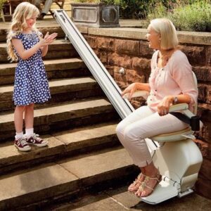 Slimline Outdoor Stairlift - older woman sat on straight stairlift