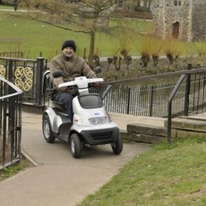TGA Breeze S4 - Older man using mobility scooter - white